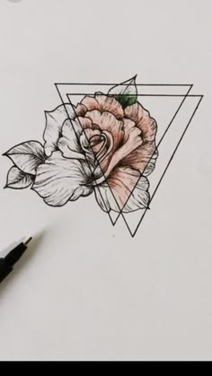 a drawing of a rose on paper with a triangle in the background and a pen next to it