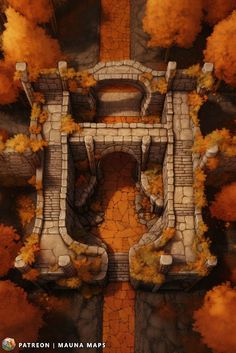 an aerial view of a stone bridge surrounded by trees and rocks in autumn colors with yellow leaves on the ground