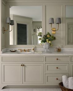 a large bathroom with two sinks and mirrors