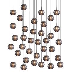 a bunch of lights that are hanging from a chandelier with many balls on it