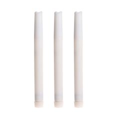 three white candles sitting next to each other