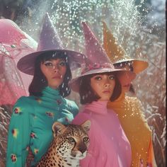 two women wearing hats and holding umbrellas with a leopard in front of them,