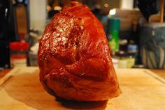 a piece of meat sitting on top of a wooden cutting board