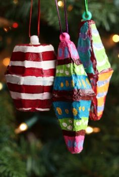 an ornament hanging from a christmas tree with the words painted egg carton ornaments