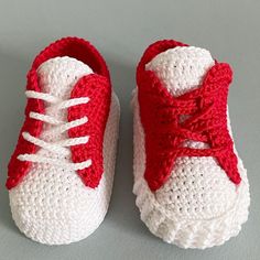 crocheted red and white baby shoes with laces