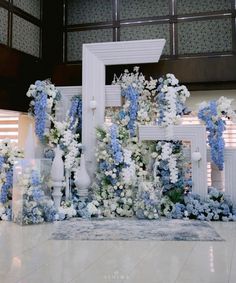 an arrangement of blue and white flowers on display