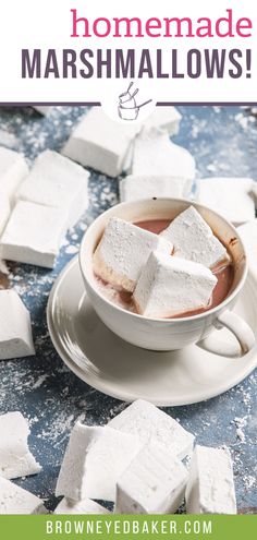 homemade marshmallows in a white cup on a saucer surrounded by sugar cubes