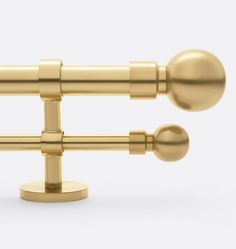 an image of a pair of gold curtain rods on a white background with clippings