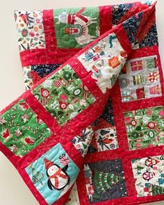 two christmas themed quilts on top of each other, one red and the other green