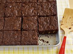 a tin with brownies in it sitting on top of a table