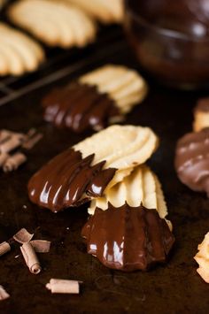 chocolate dipped cookies are arranged on a baking sheet