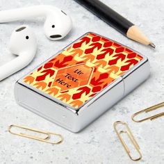 an orange and yellow pattern with the words i'm not here on it next to earbuds