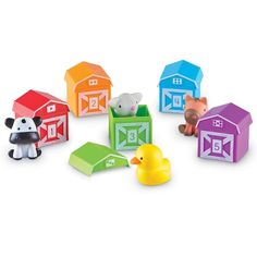 several wooden toys are arranged in the shape of farm animals and barn blocks on a white background