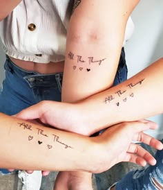 two girls with matching tattoos on their arms