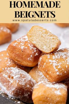 homemade doughnuts piled on top of each other with powdered sugar