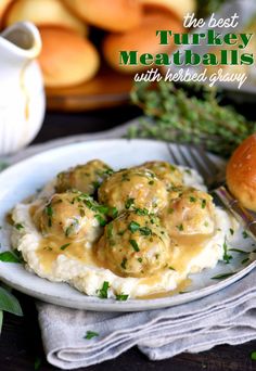 the best turkey meatballs with herb gravy on a white plate next to rolls