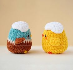 two crocheted birds sitting next to each other