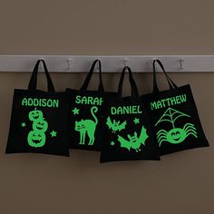 glow in the dark halloween shopping bags hanging from a hook on a door hanger