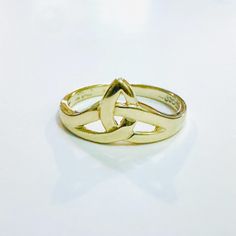 a gold ring sitting on top of a white table