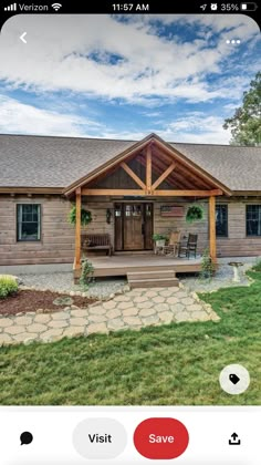 an iphone photo of a log cabin home with porch and covered front porch, sitting on the grass