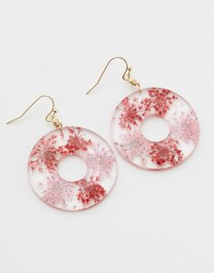 red and white dangle earrings with flowers on them