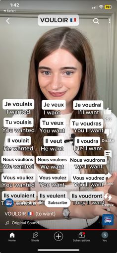 the girl is looking at her cell phone with words in french and english on it