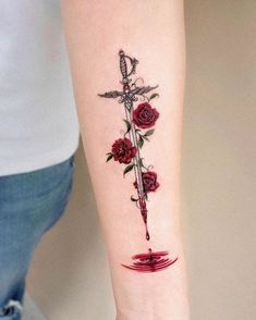 a woman's arm with a rose and dagger tattoo on the left inner forearm