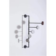 an iron and glass wall light with five lights on each side, mounted against a white wall