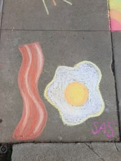 sidewalk chalk art with eggs and bacon on it