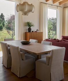 a dining room table surrounded by chairs and couches