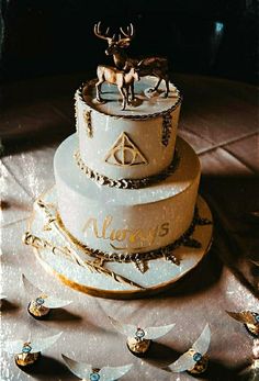 a three tiered cake with an image of a deer on top