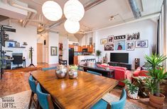 a living room filled with furniture and a wooden table in front of a flat screen tv