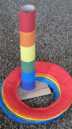 a colorful paper plate on the ground with a toy in it