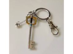 a key chain with a metal lock and two keys attached to it