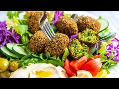 a white plate topped with salad and meatballs