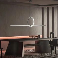 a modern dining room with an oval light hanging over the table