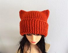 a knitted cat hat on top of a mannequin head