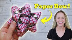 a woman holding up a red and white bow with the words paper bowl below it