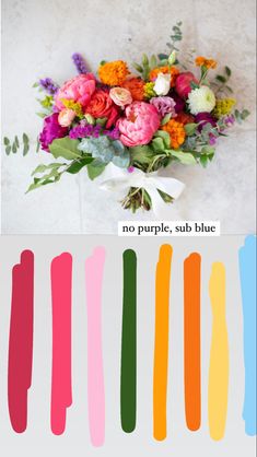 a bunch of flowers sitting on top of a white table next to an orange and pink flower