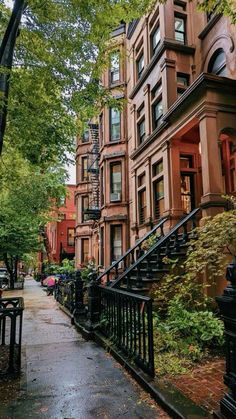 an alleyway with many brownstone buildings and wrought iron railings on both sides