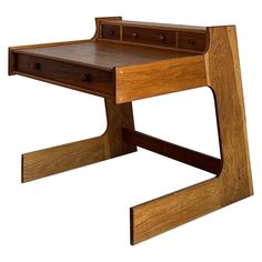 a wooden desk with two drawers on one side and an open drawer on the other