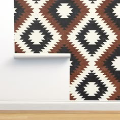 a brown and white wallpaper with black and white geometric design on the wall next to a wooden floor