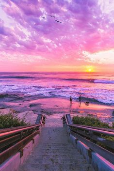 stairs leading down to the beach at sunset