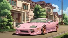 a pink sports car parked on the side of a road in front of some houses