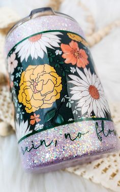 a purple glittered jar with flowers on it