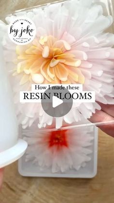 a person is holding a plastic container with flowers in it and the words how i made these resinin flooms