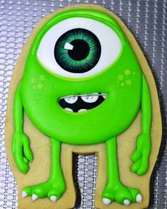 a cookie shaped like a monster with green eyes