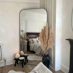 a bedroom with a large mirror on the wall