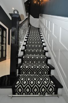 a set of stairs with black and white carpet