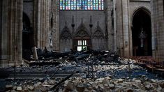 the interior of an old cathedral with rubble and stained glass windows in it's center